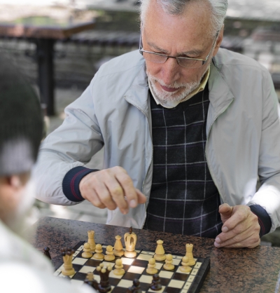 close-up-friends-playing-chess-outdoors